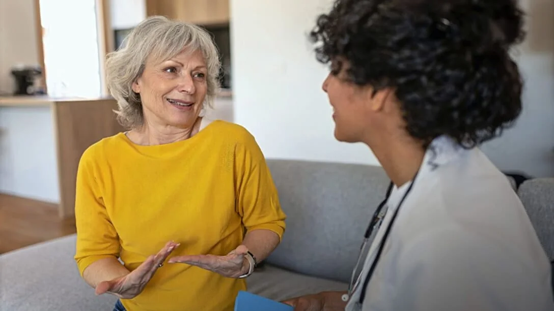 Older woman talking with a doctor, actor portrayal