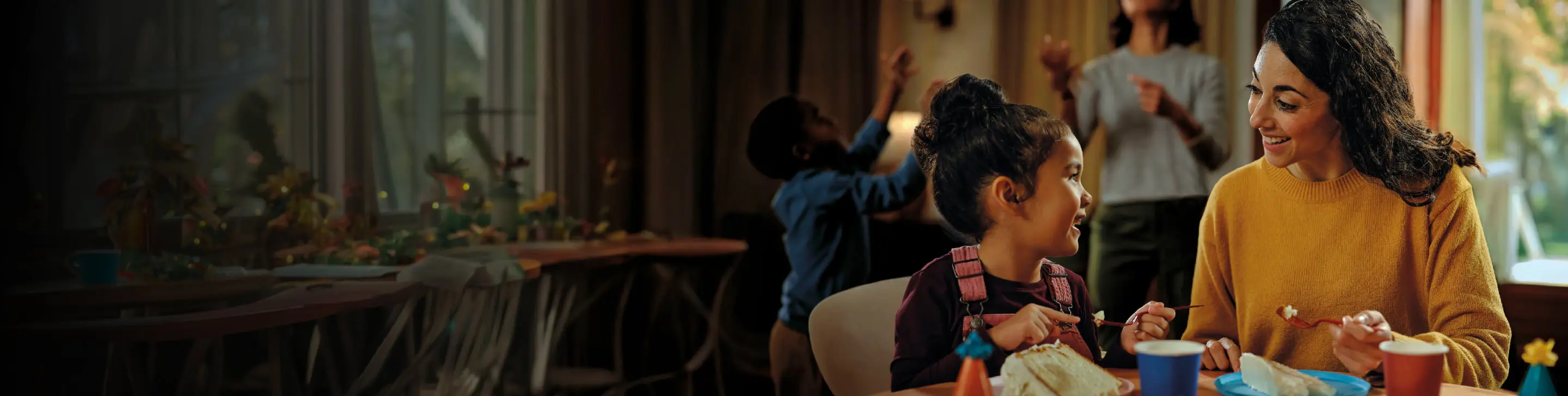 Woman feeding a child at a table, actor portrayal of family life with steady Ig levels on Hizentra