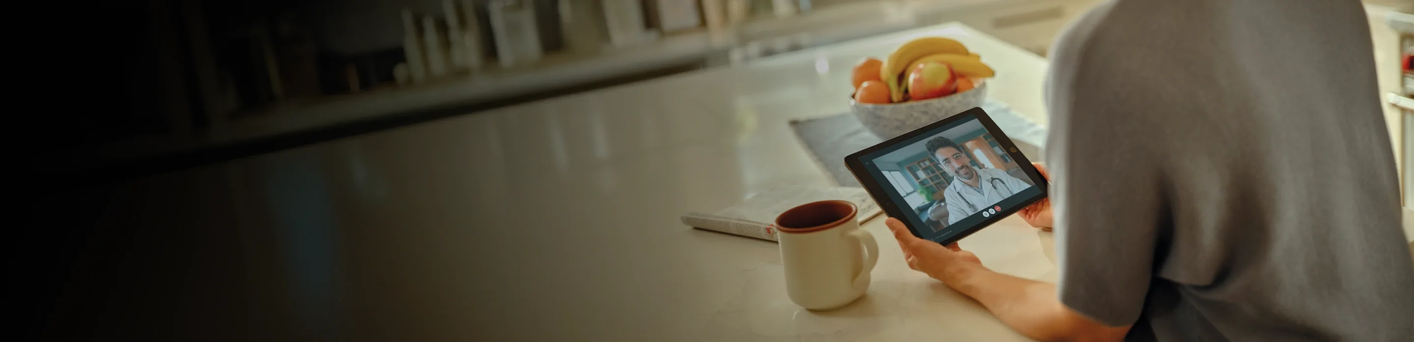 Person on a video call with a doctor, actor portrayal
